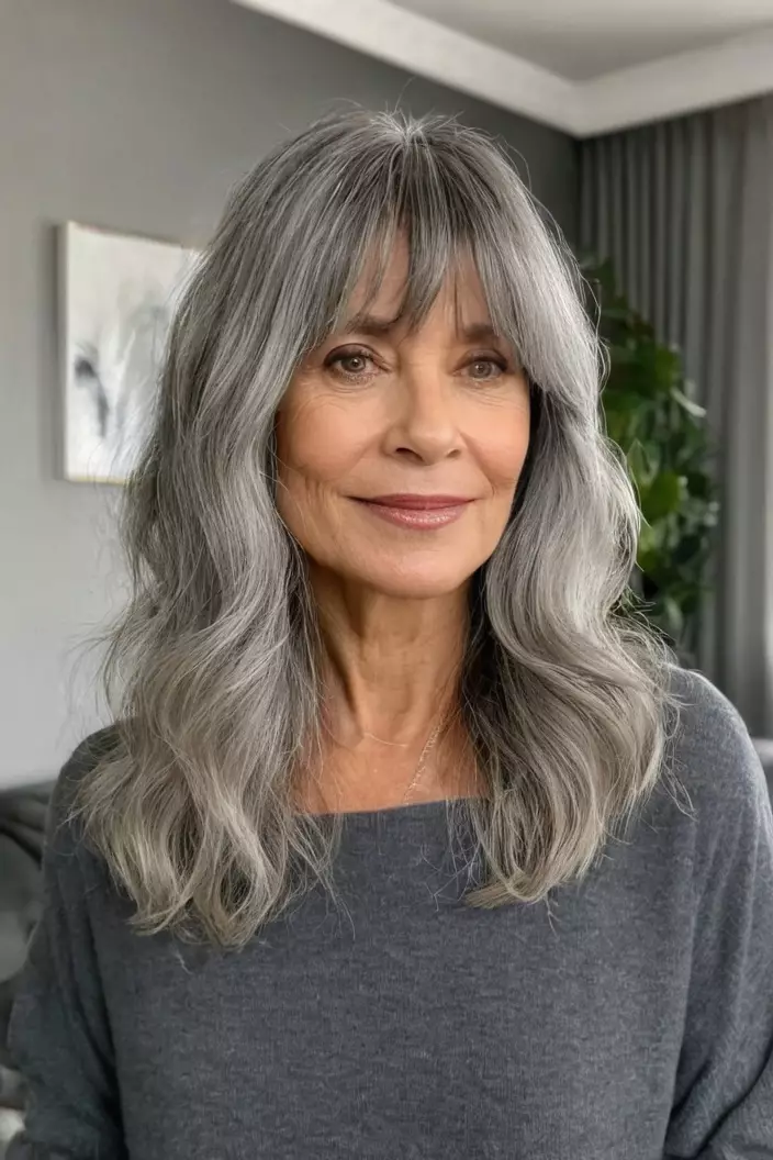 A photo of a 40-year-old Linda, soft gray waves with curtain bangs, front view, living room background  