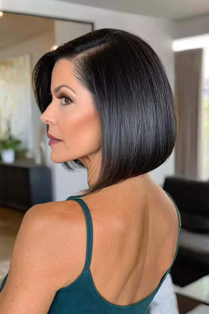 A photo of a 49-year-old Nicole, bob with tapered back for thick hair, living room background  