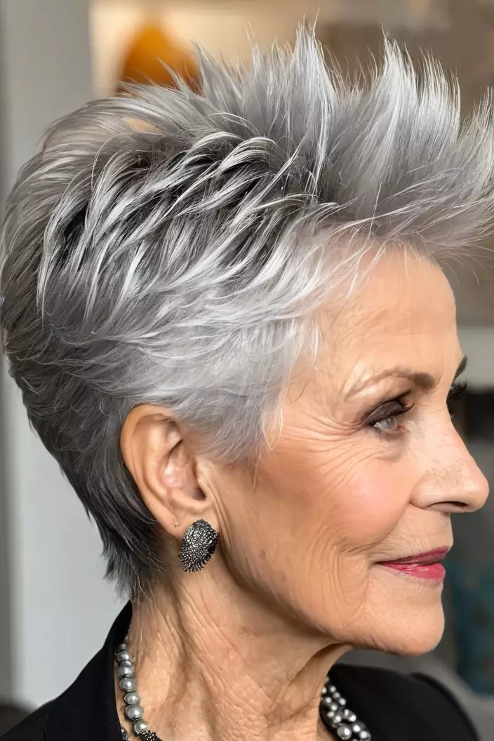 A photo of a 72-year-old Barbara, spiky silver pixie hairstyle, side view, living room background  