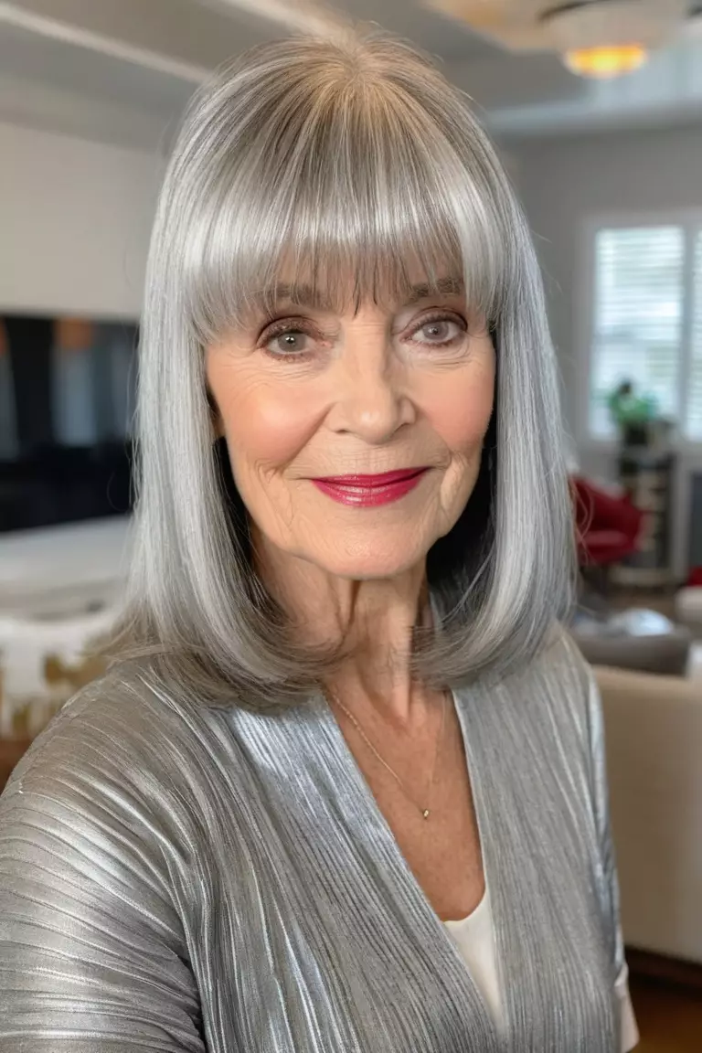 A photo of a 64-year-old Emily, silver lob with bangs, front view, living room background