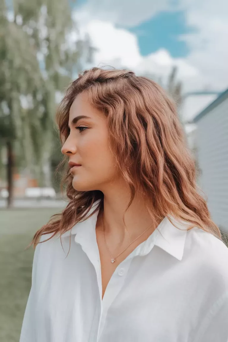 A beautiful woman with a wavy rose brown hairstyle, Side view, summer background