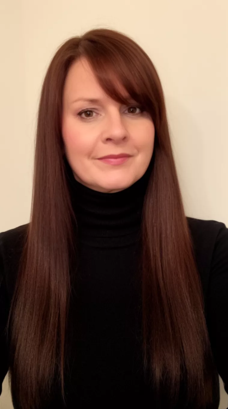 casual photo of a 41-year-old woman wearing a black turtleneck with a chocolate cherry long straight hairstyle