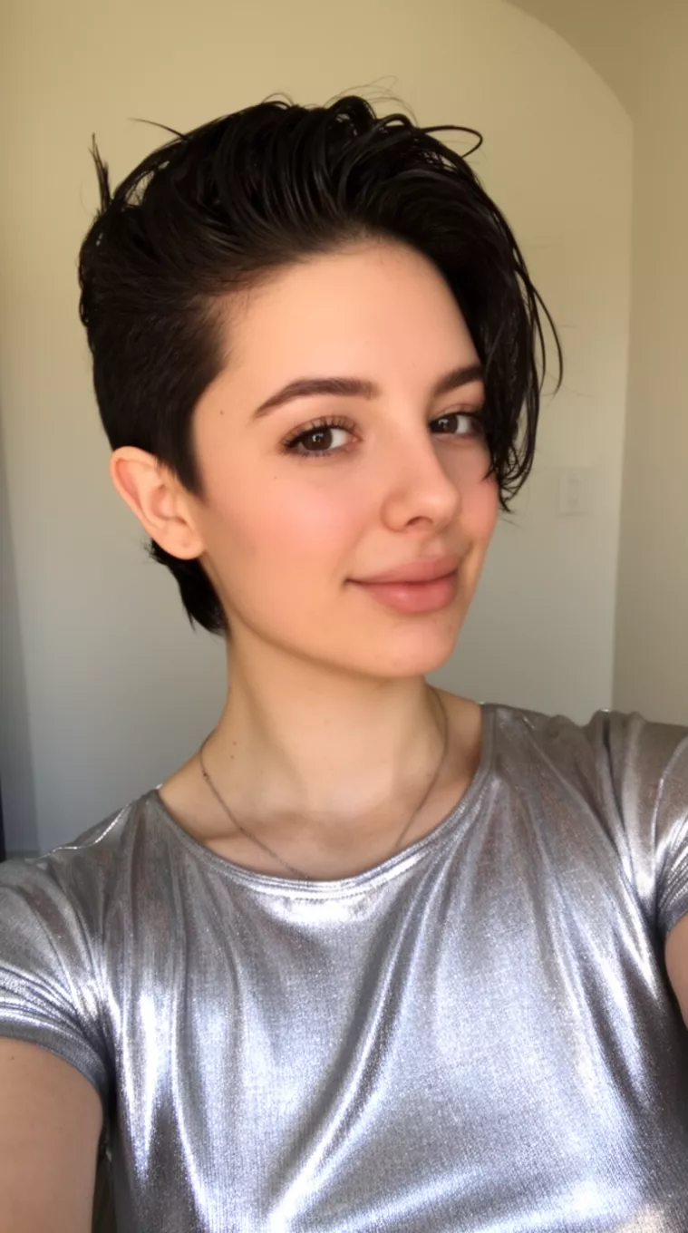 selfie of a 22-year-old woman wearing a silver metallic top with a Wet-Look Sculpted Crop hairstyle, minimal background