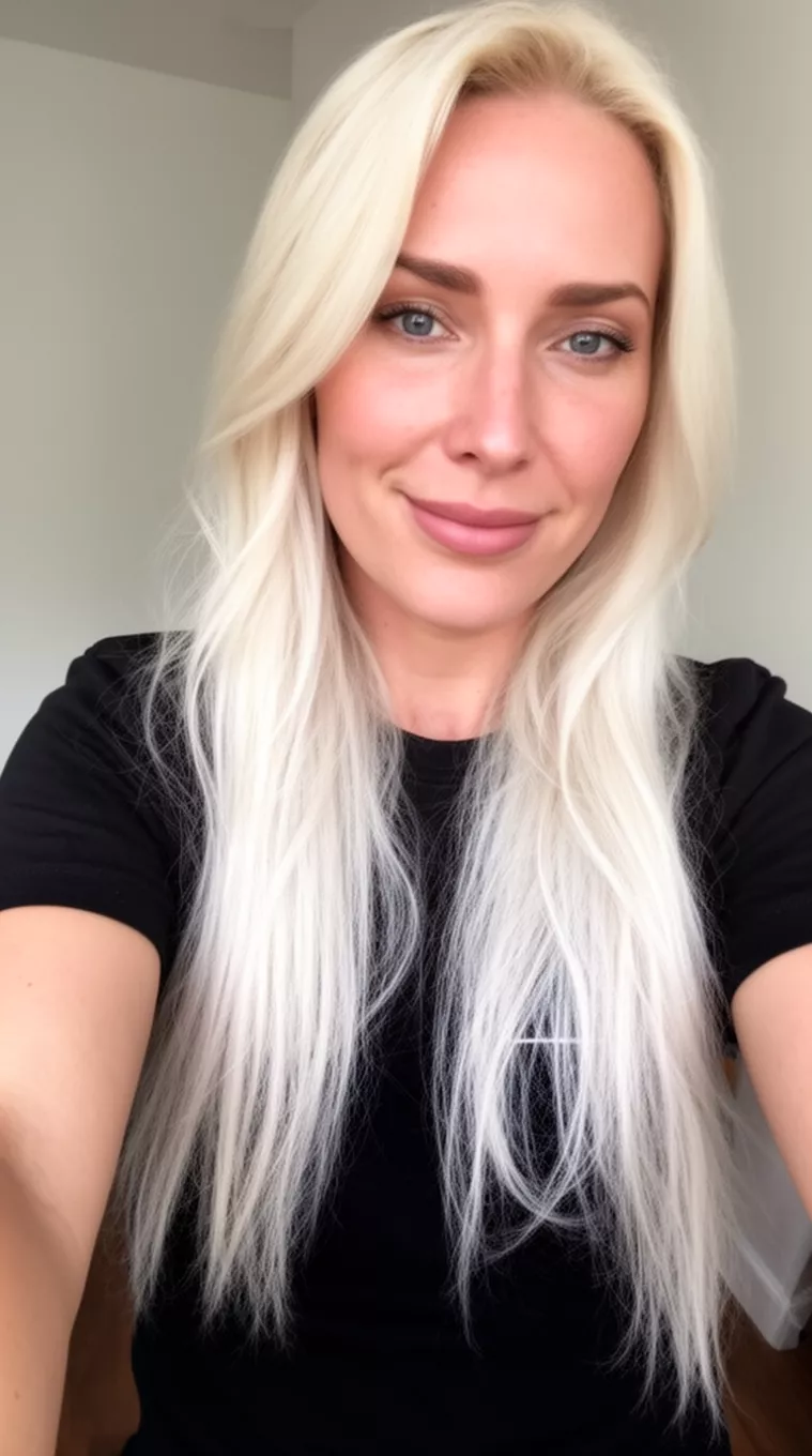 selfie of a 36-year-old woman wearing a black t-shirt with a Platinum Pearl Blonde colored long hairstyle, minimal background