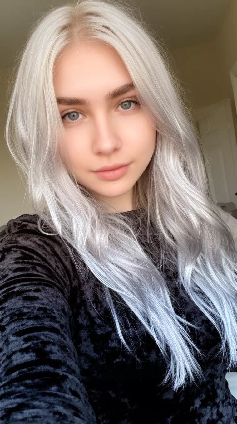 selfie of a 24-year-old woman wearing a black velvet top with Metallic Platinum hair