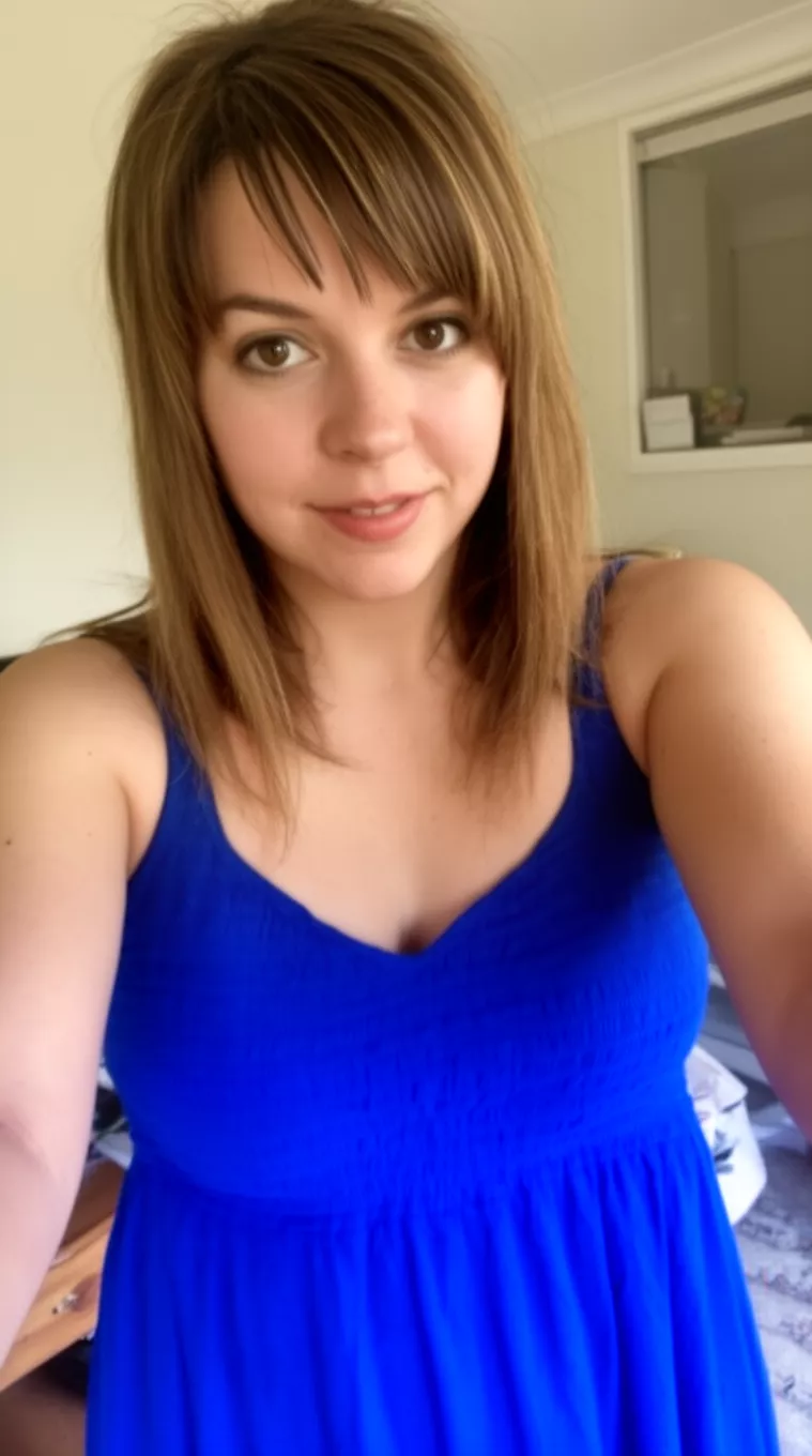 selfie of a 27-year-old woman wearing a royal blue sun dress with a hairstyle with Side Fringes