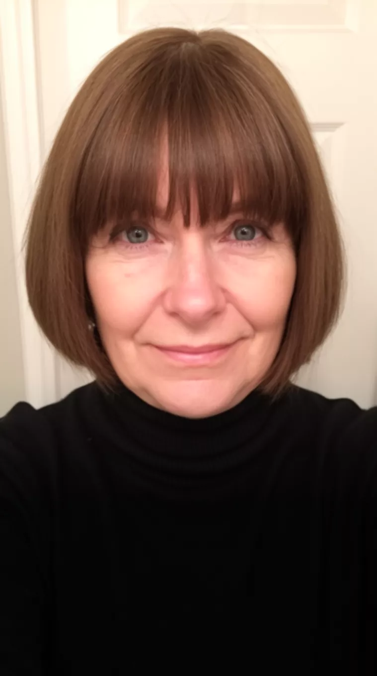 selfie of a 56-year-old woman wearing a black turtleneck with a Curtain Bangs Bob