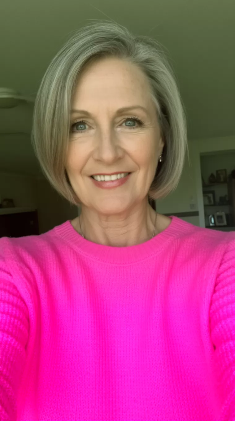 selfie of a 60-year-old woman wearing a candy pink sweater with a Flippy Ends Bob