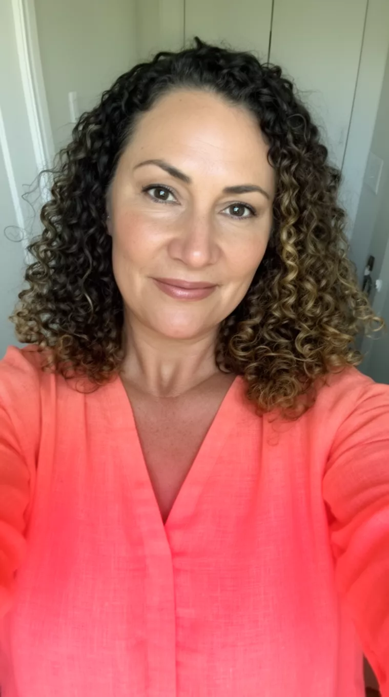 selfie of a 35-year-old woman wearing a coral linen top with a Curl Contour