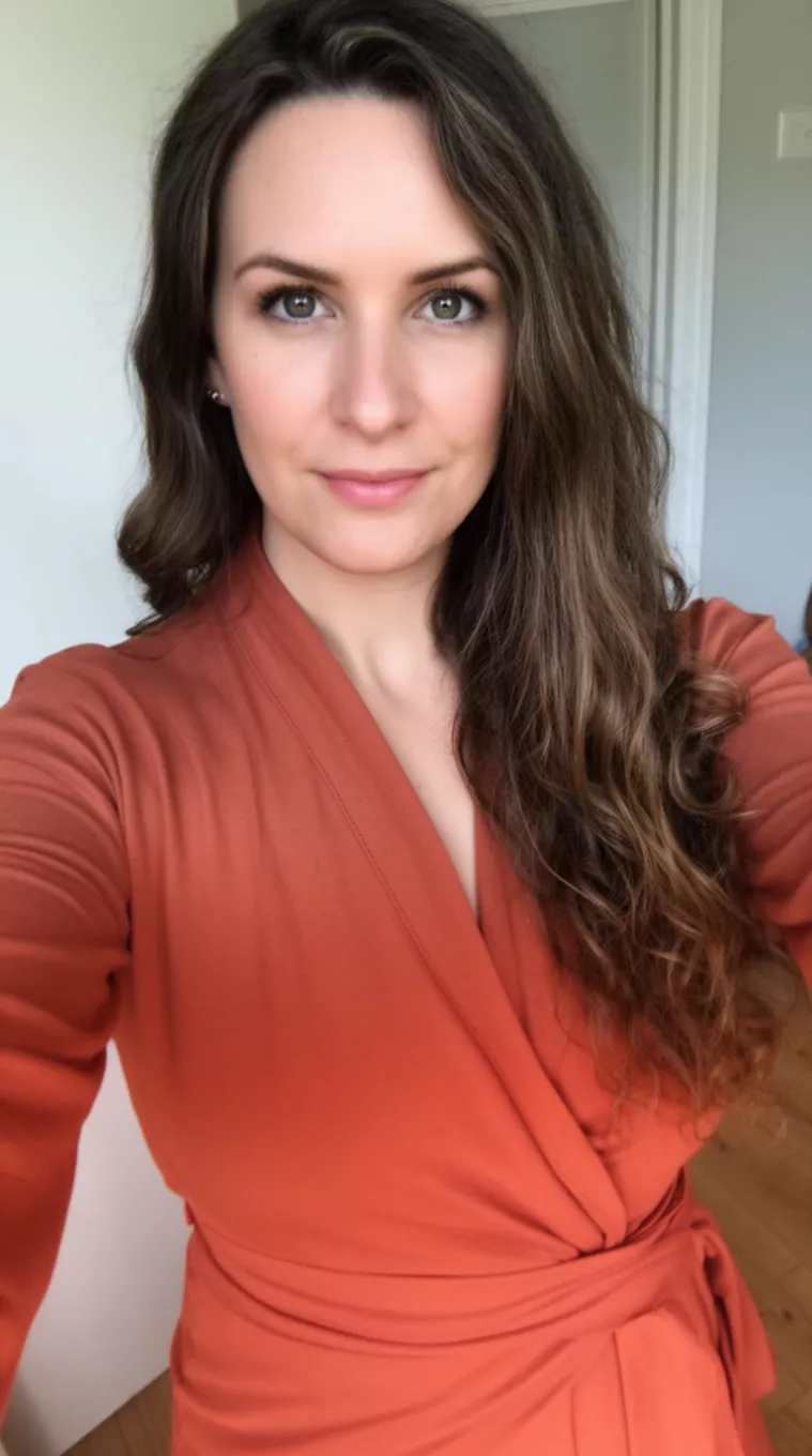 selfie of a 27-year-old woman wearing a terracotta wrap top with a Jaw-Lined Layer
