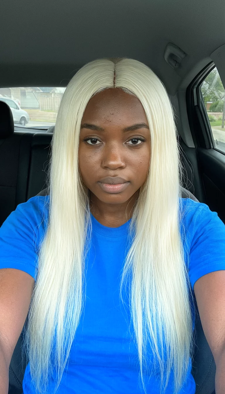 Icy Platinum Silk selfie of a 23-year-old black woman wearing a blue t-shirt with a platinum blonde colored long, straight hairstyle, front view, inside a car