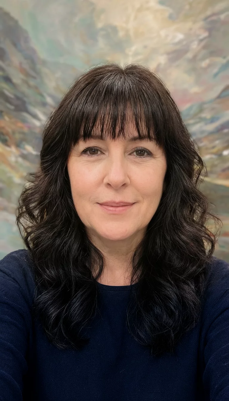 selfie of a 42-year-old woman wearing a dark top with dark, wavy hair and soft bangs hairstyle, front view, artistic background
