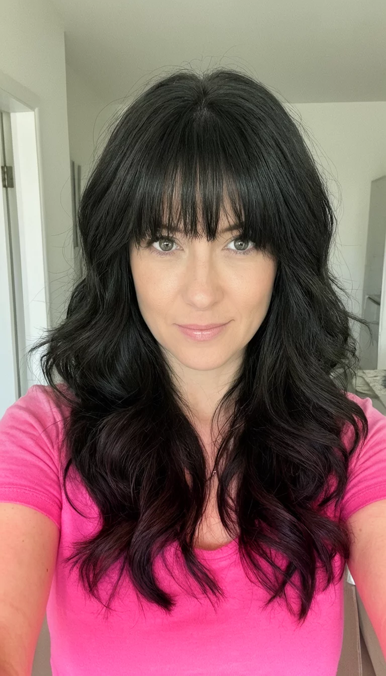 Layered Pink Top Pink Vibes selfie of a 30-year-old woman wearing a pink top with a long, dark, layered wavy medium length hairstyle featuring bangs, front view, indoor setting